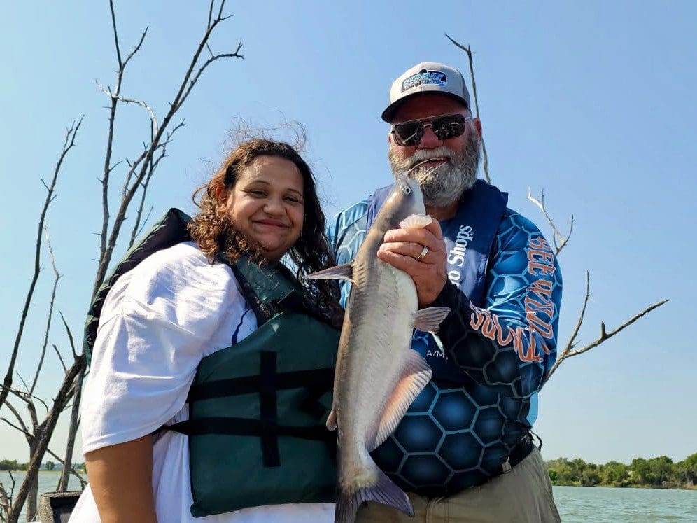 young boy showing off fish at McLane Stadium
