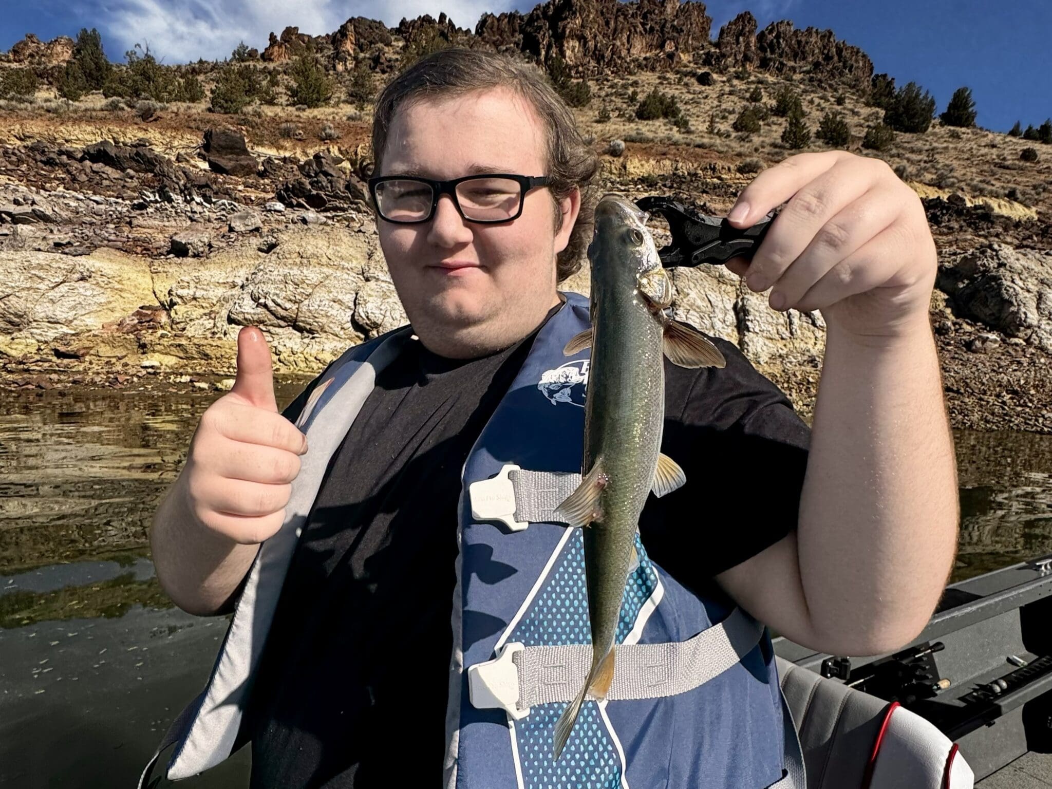 child showing off fish at prineville reservoir