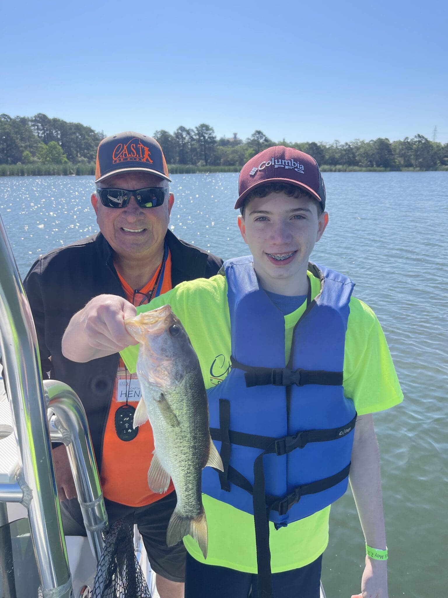 participant on boat holding a fish