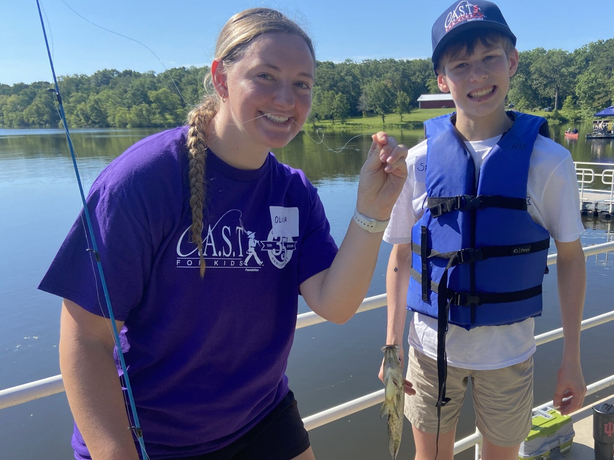 two participants holding a fish at Kemp Lake