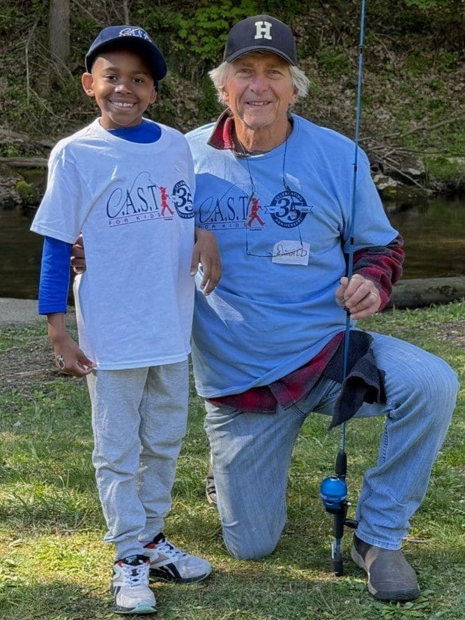 two participants showing a fish at Clarks Valley