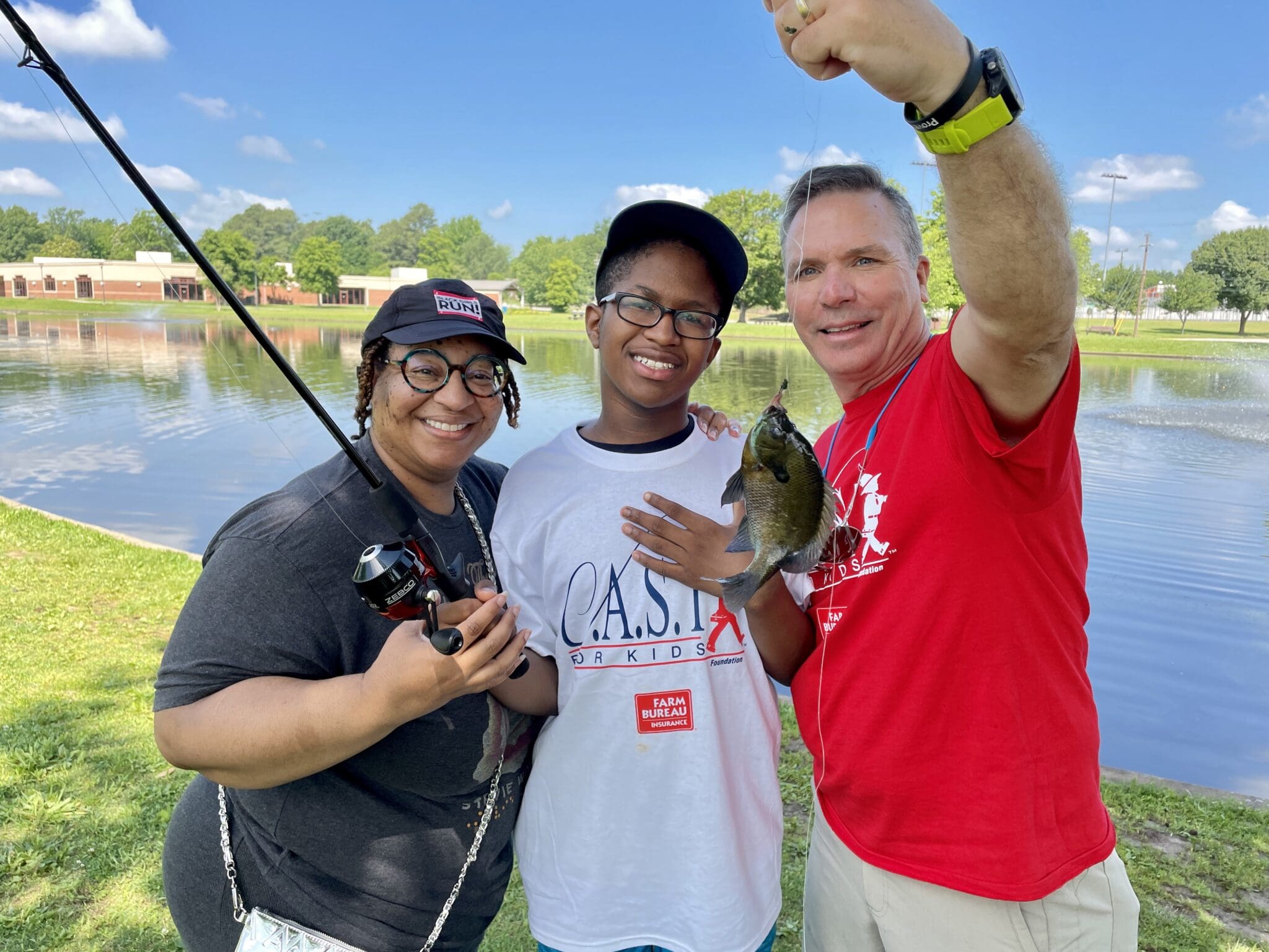 volunteers with a caught fish with young people