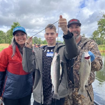 young girl and older man showing off fish at lake charles