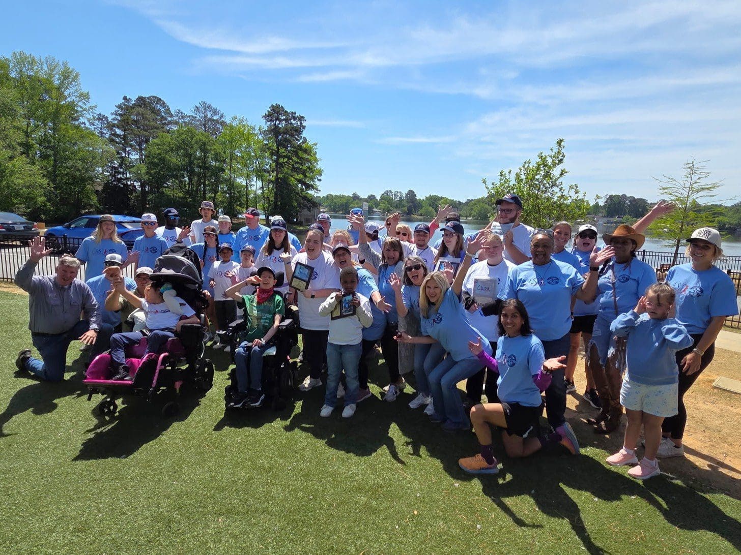 volunteers and participant holding plaques