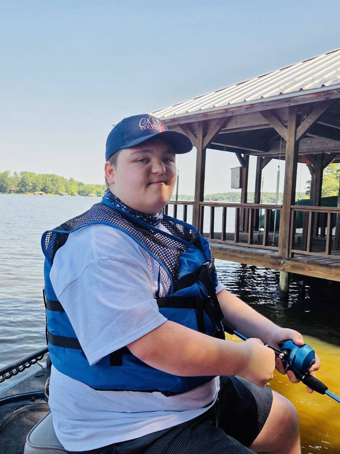 participant on boat holding a fish