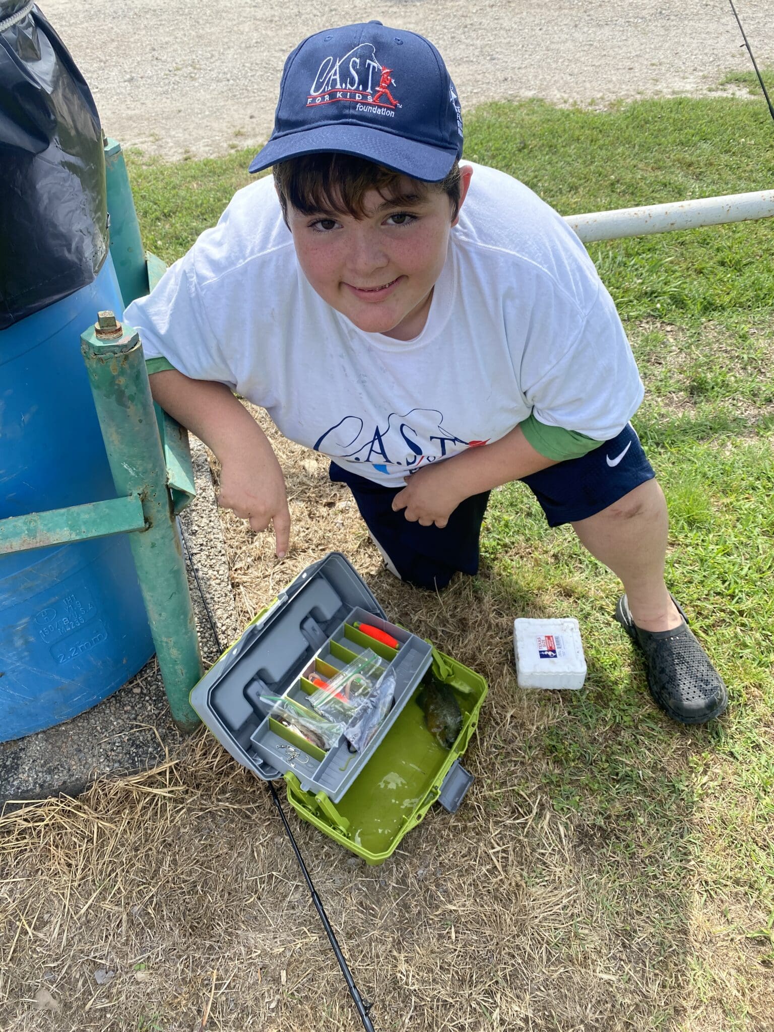 boy showing off tackle box at Lake Bonham Park
