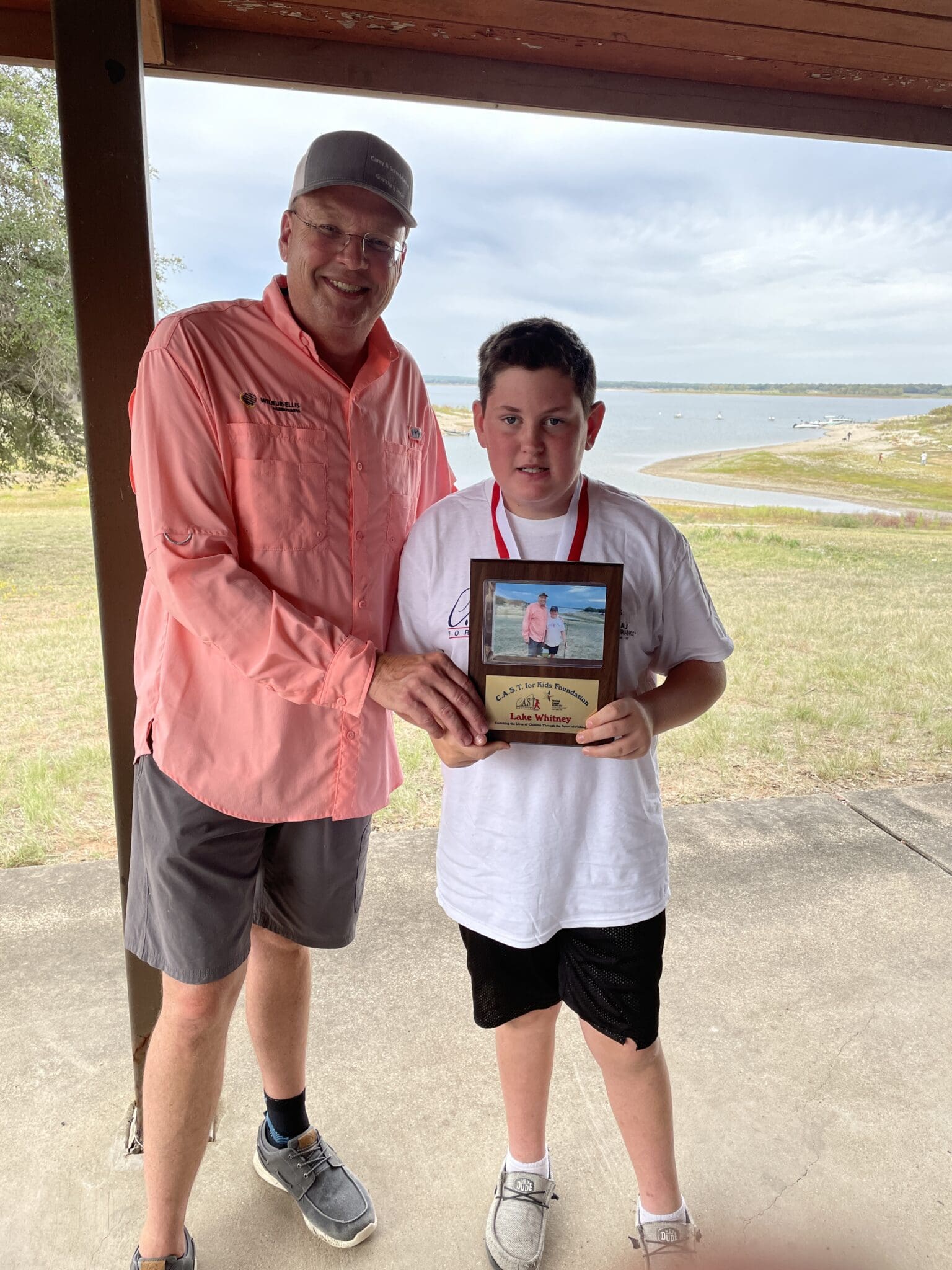 boy holding plaque at Lake Whitney
