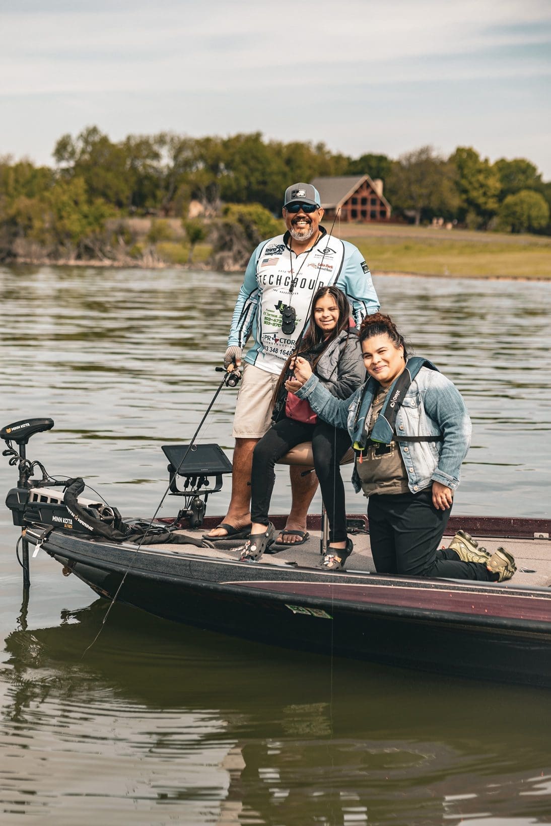 volunteer and participant with a fish in a boat