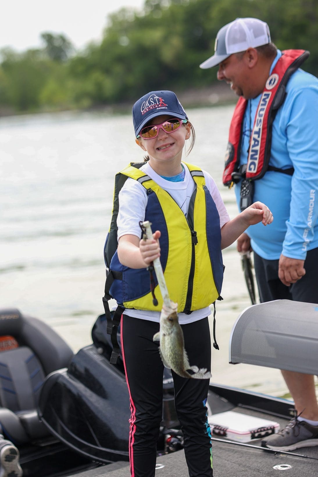 volunteer and participant with a fish
