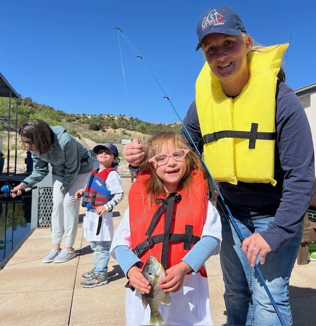 youth with CAST volunteer wearing life jackets