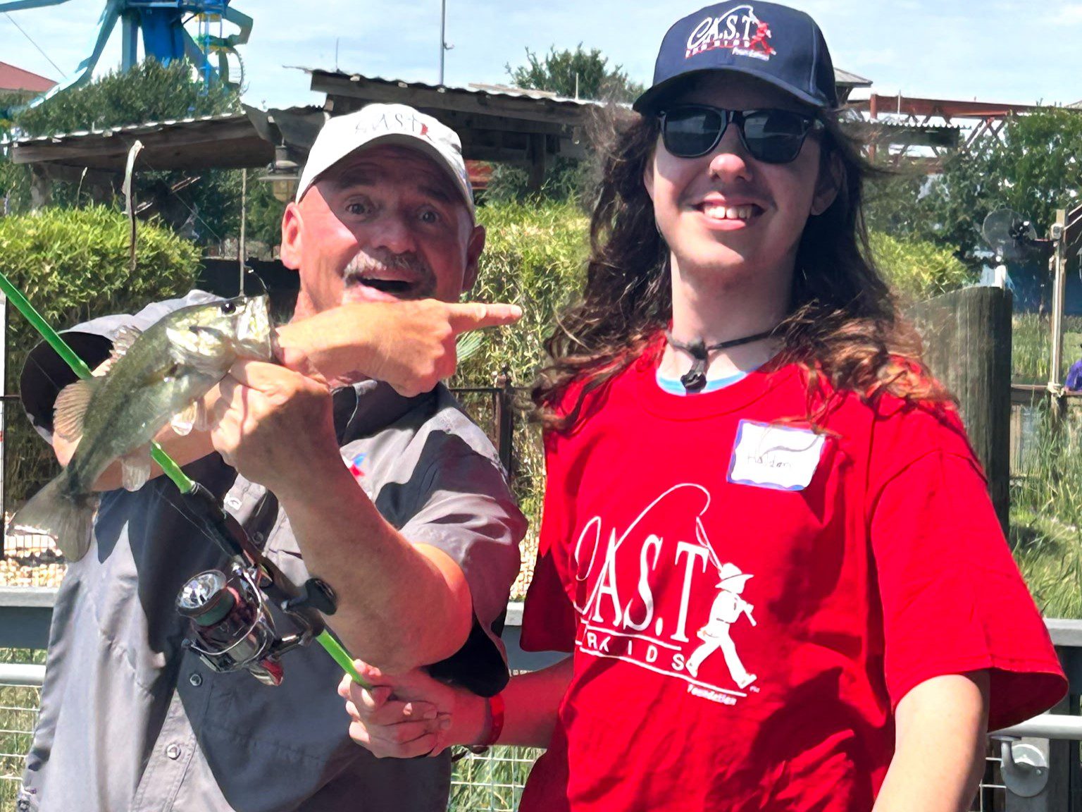 a kid holding a fish and pole