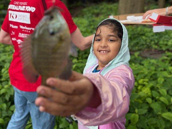 Young girl at central park pond