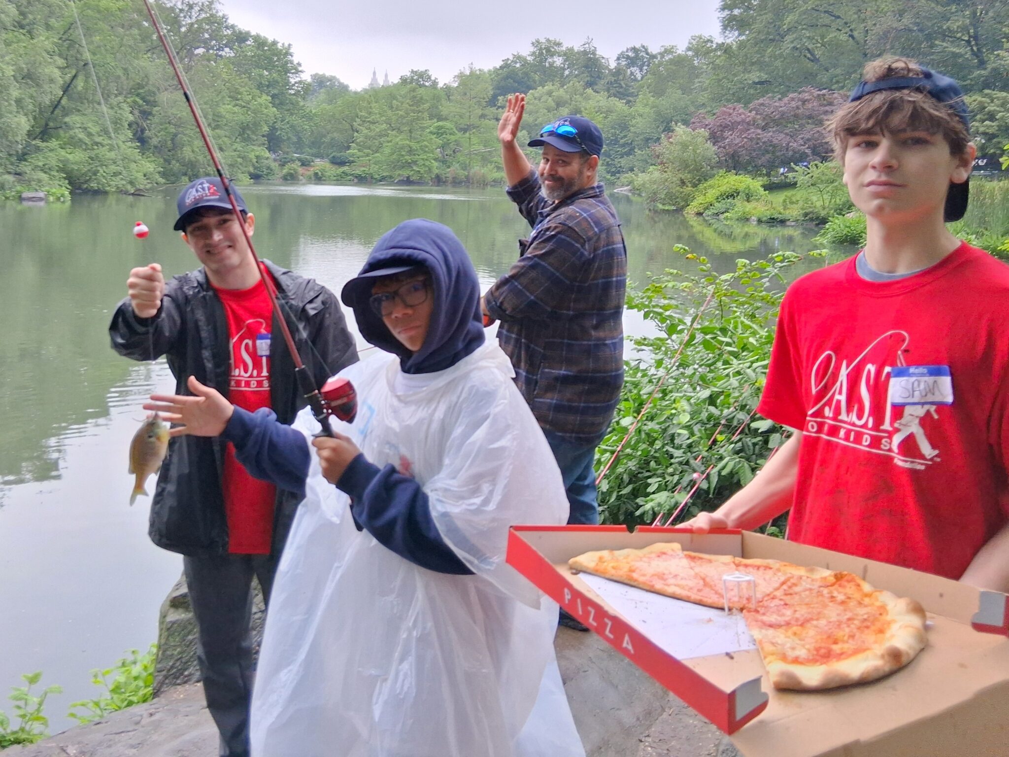 boy in poncho at central park pond