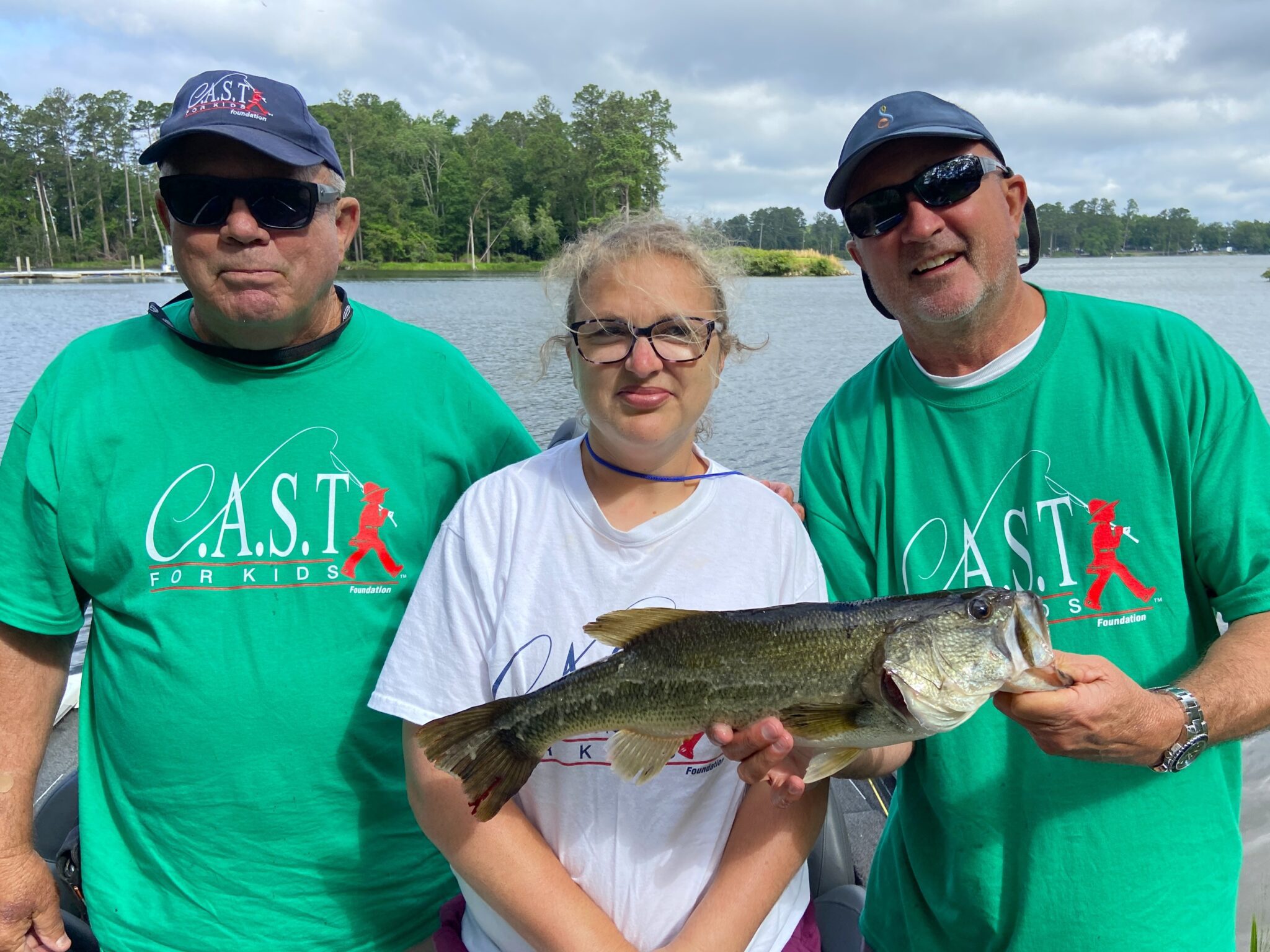 three people holding fish at lake murray sc