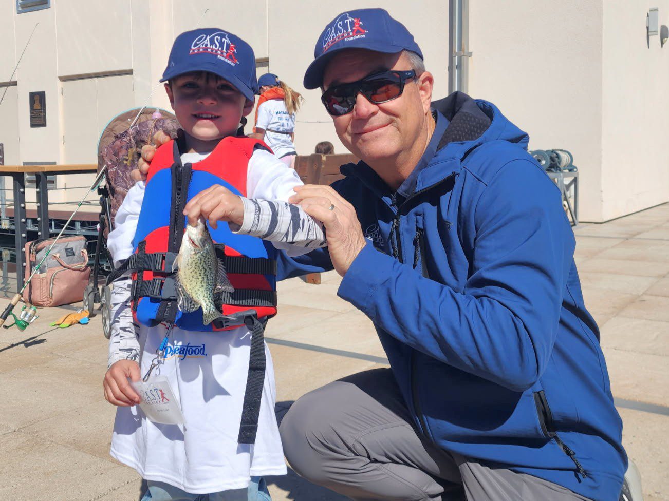 child holding fish at navajo lake