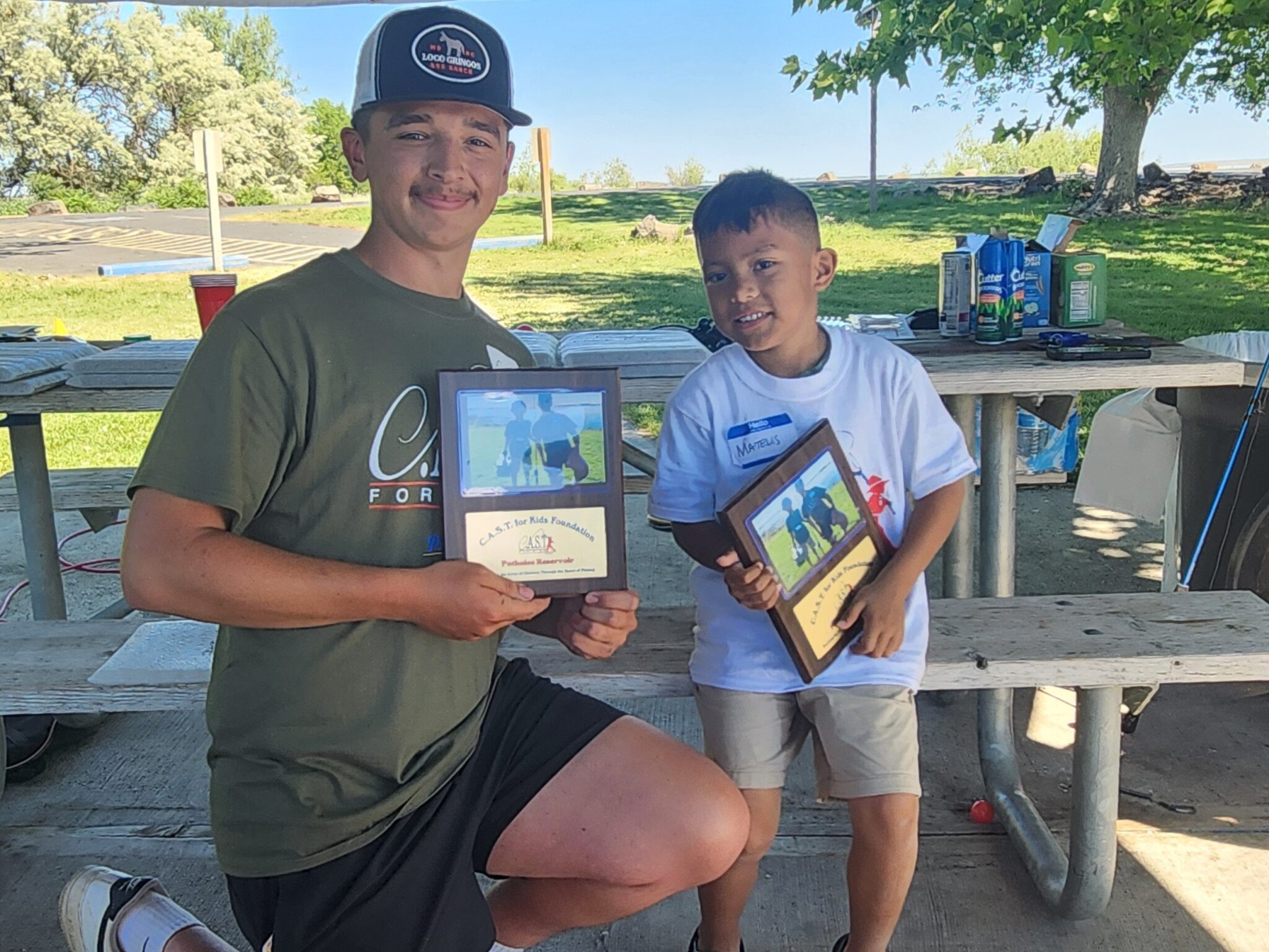 two people displaying plaques at potholes reservoir