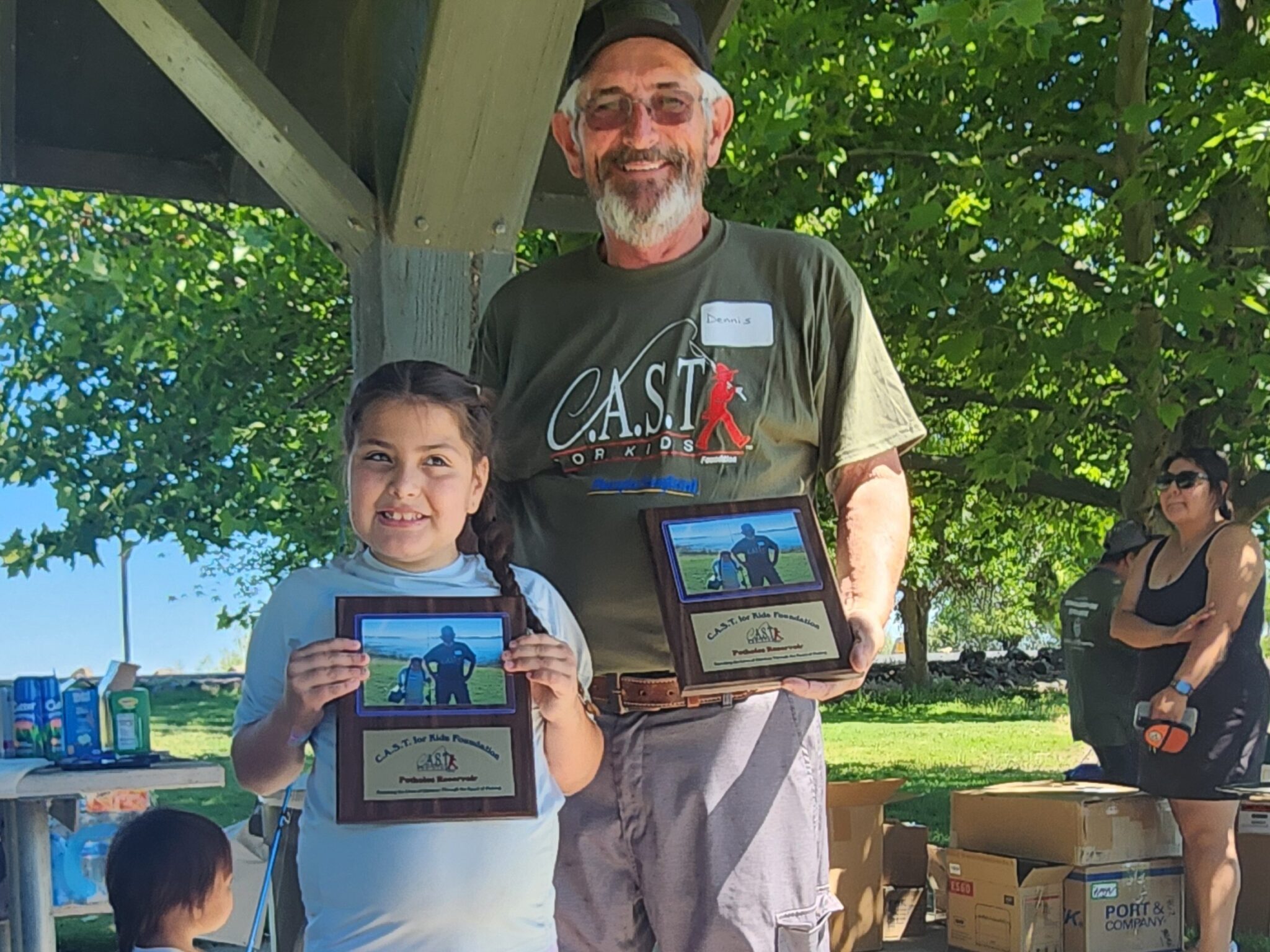a man and boy holding plaques at potholes reservoir