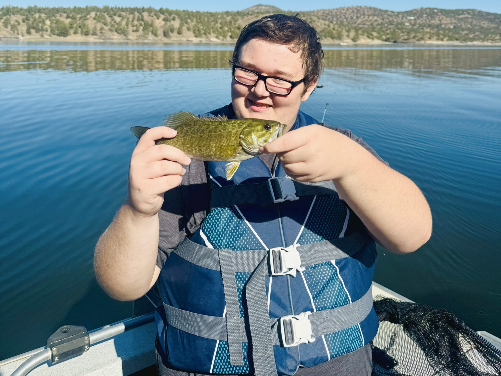 young kid showing off fish at prineville reservoir
