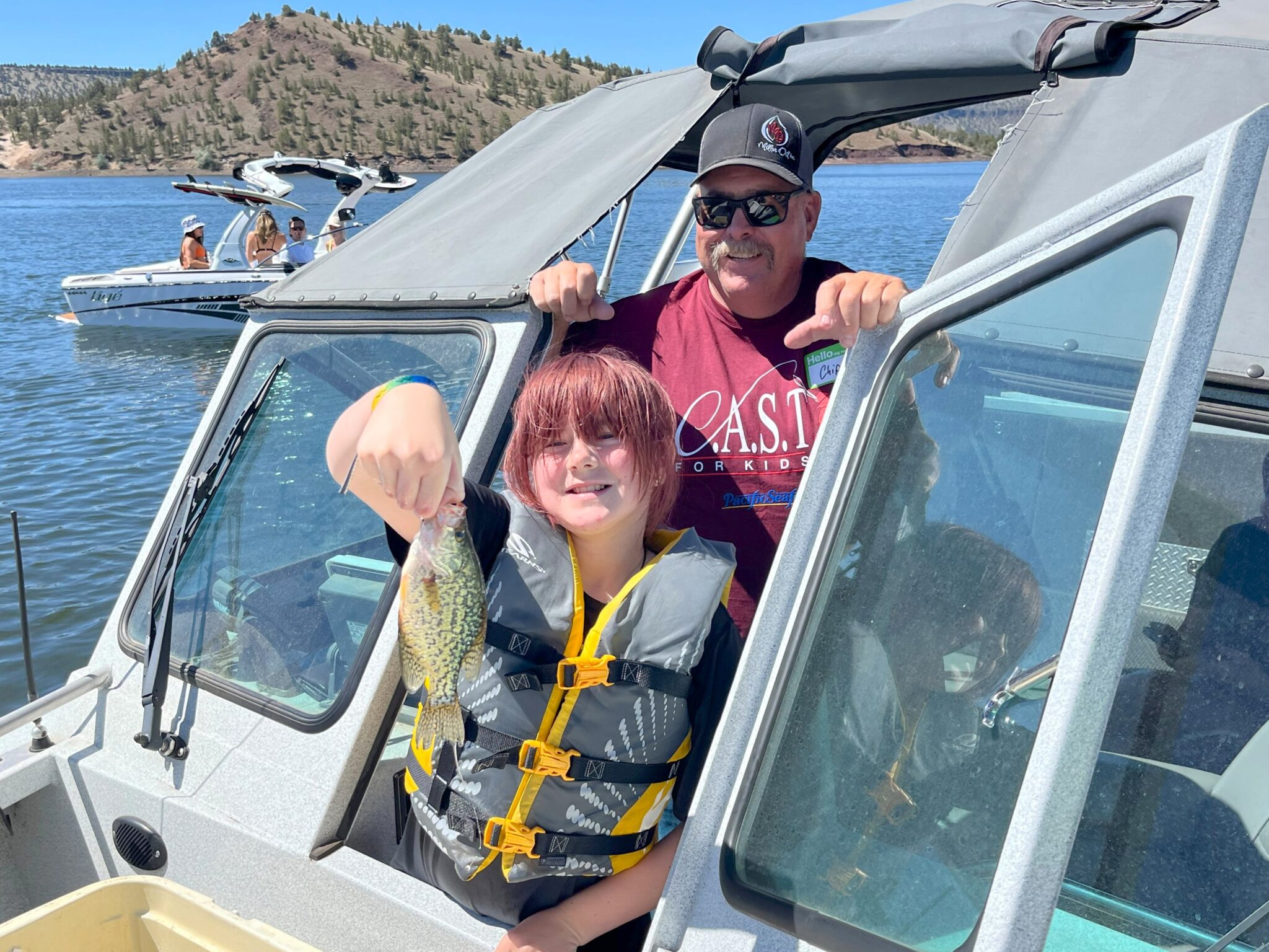 child showing off fish at prineville reservoir