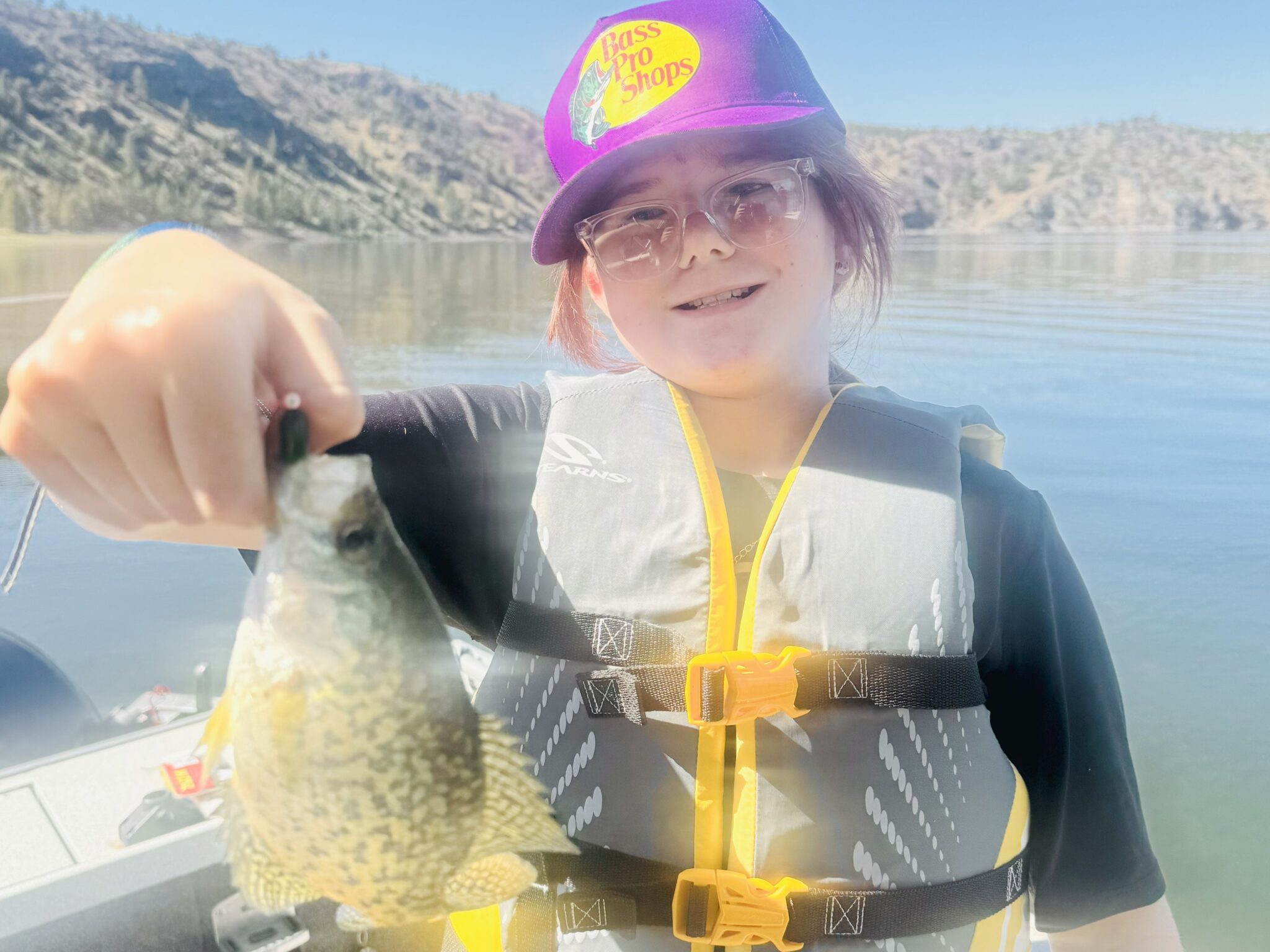 young female participant showing fish at prineville reservoir