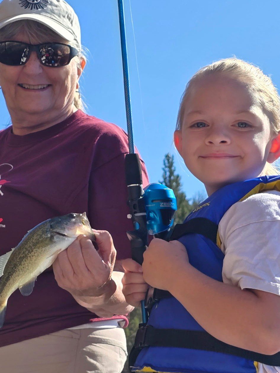young boy showing fish at prineville reservoir
