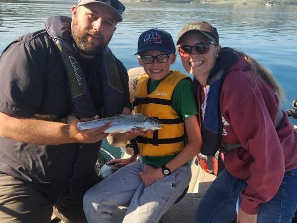 child participant showing fish at strawberry reservoir