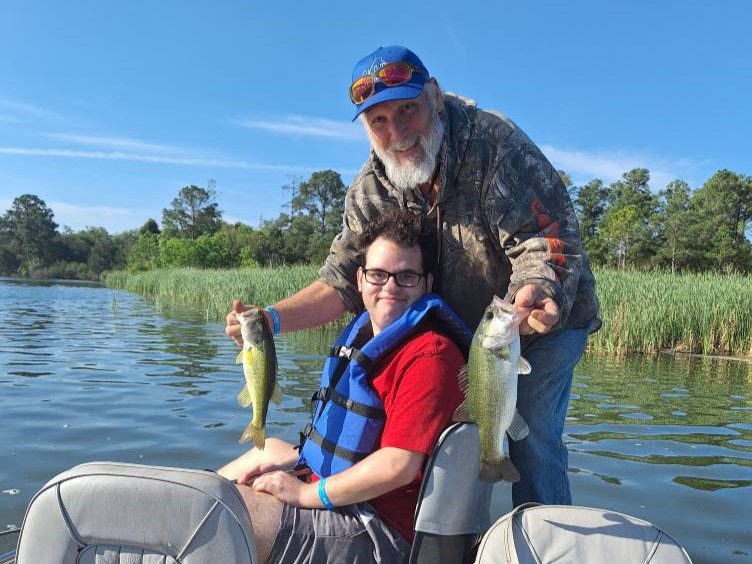 participant on boat holding a fish