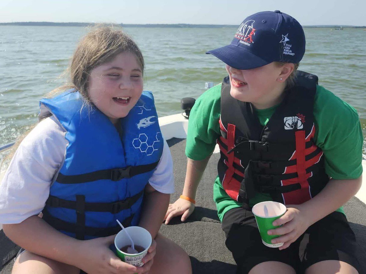 participants on boat at McLane Stadium