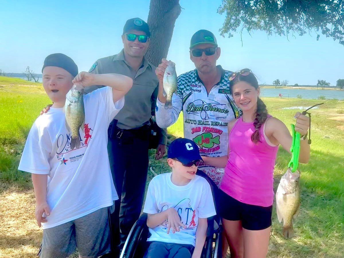 boy showing plaque at McLane Stadium