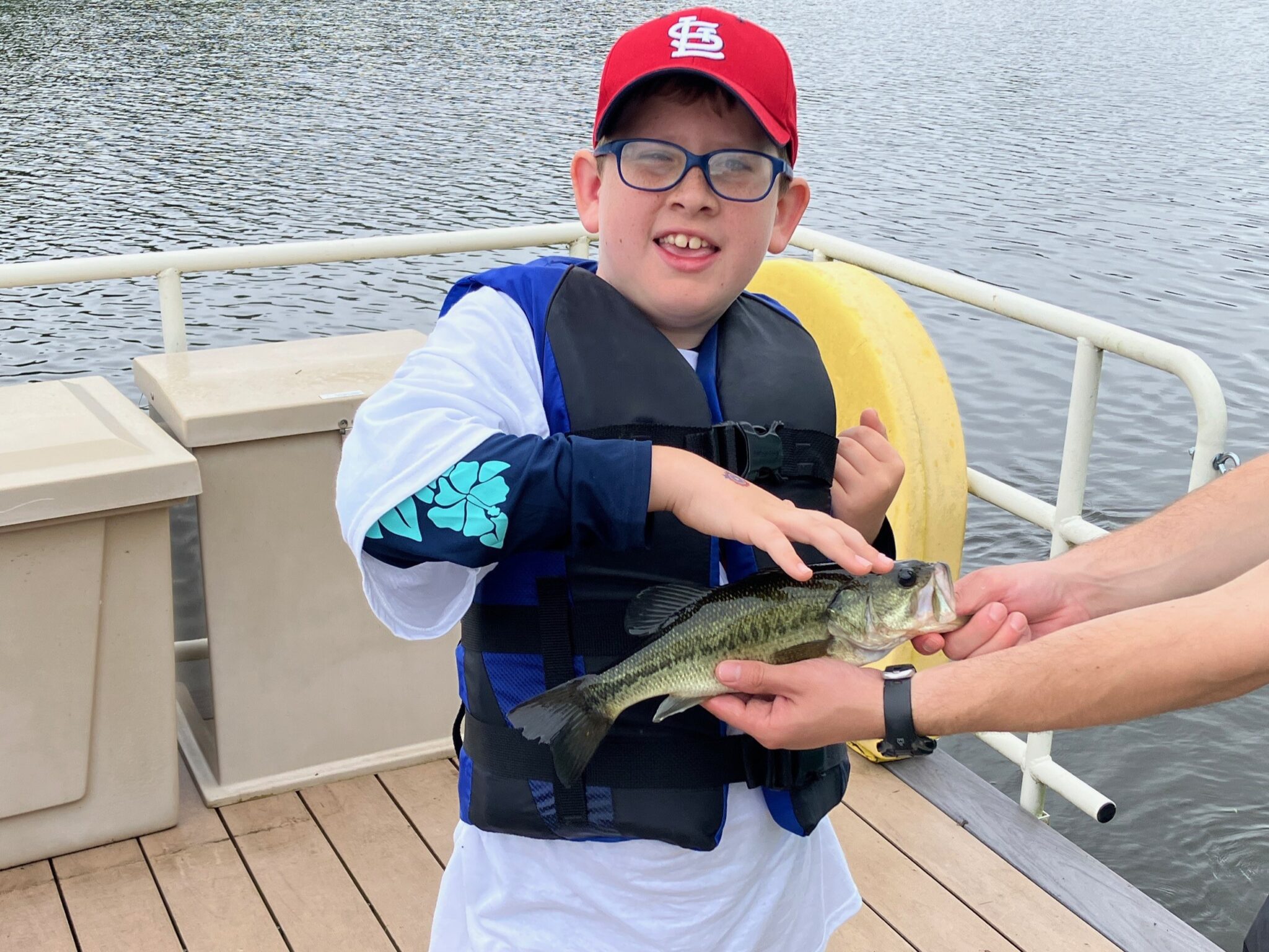 Young boy holding fish at Kemp Lake