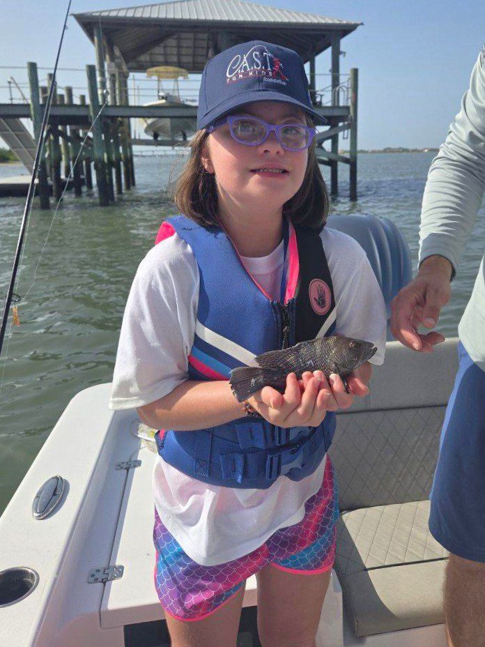 young child holding fish at st johns county