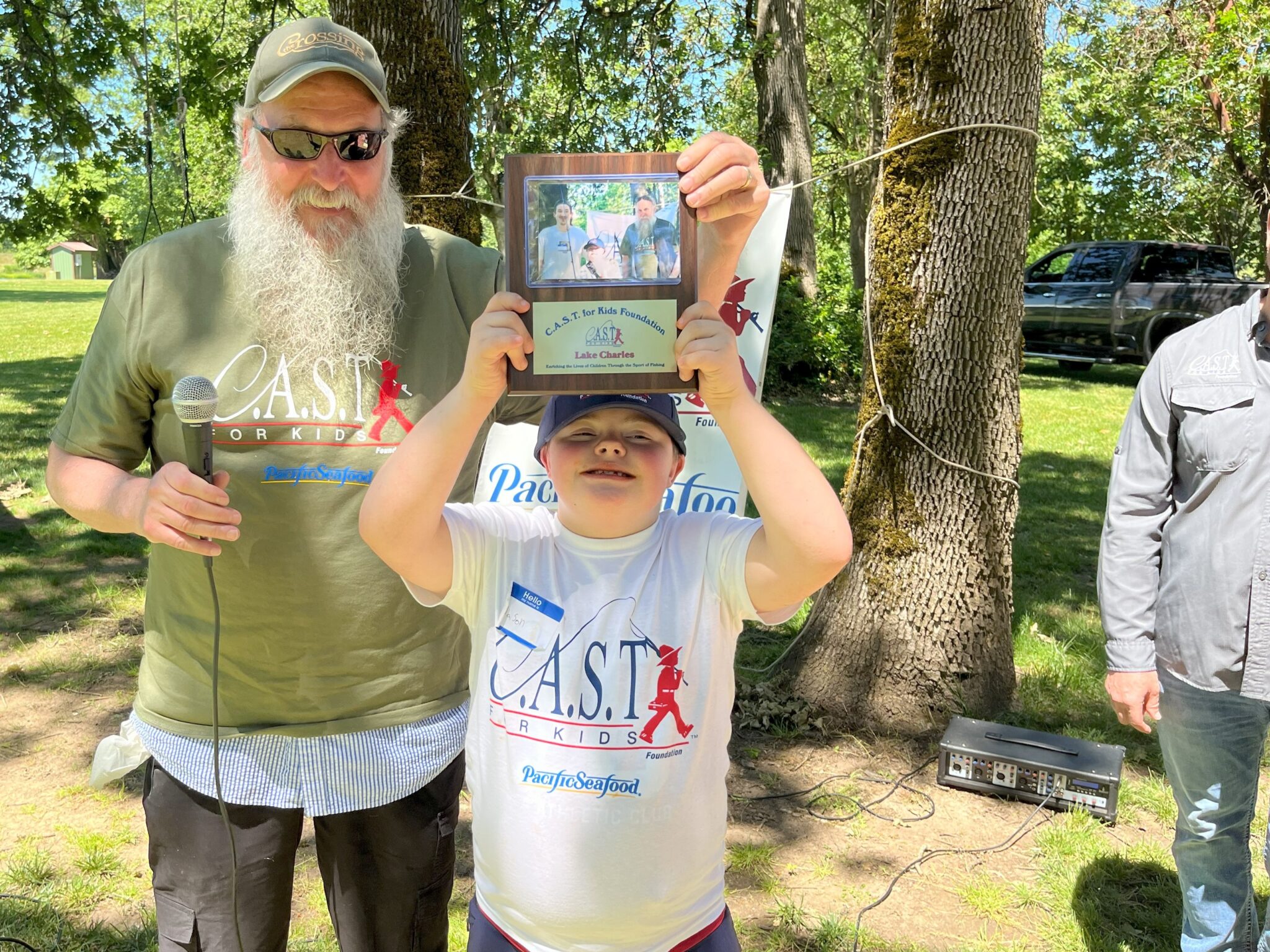 young boy showing plaque at lake charles