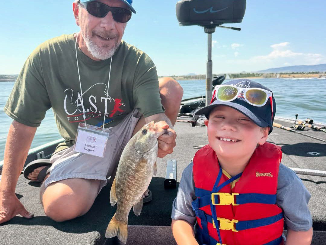 young happy boy with fish at chatfield reservoir