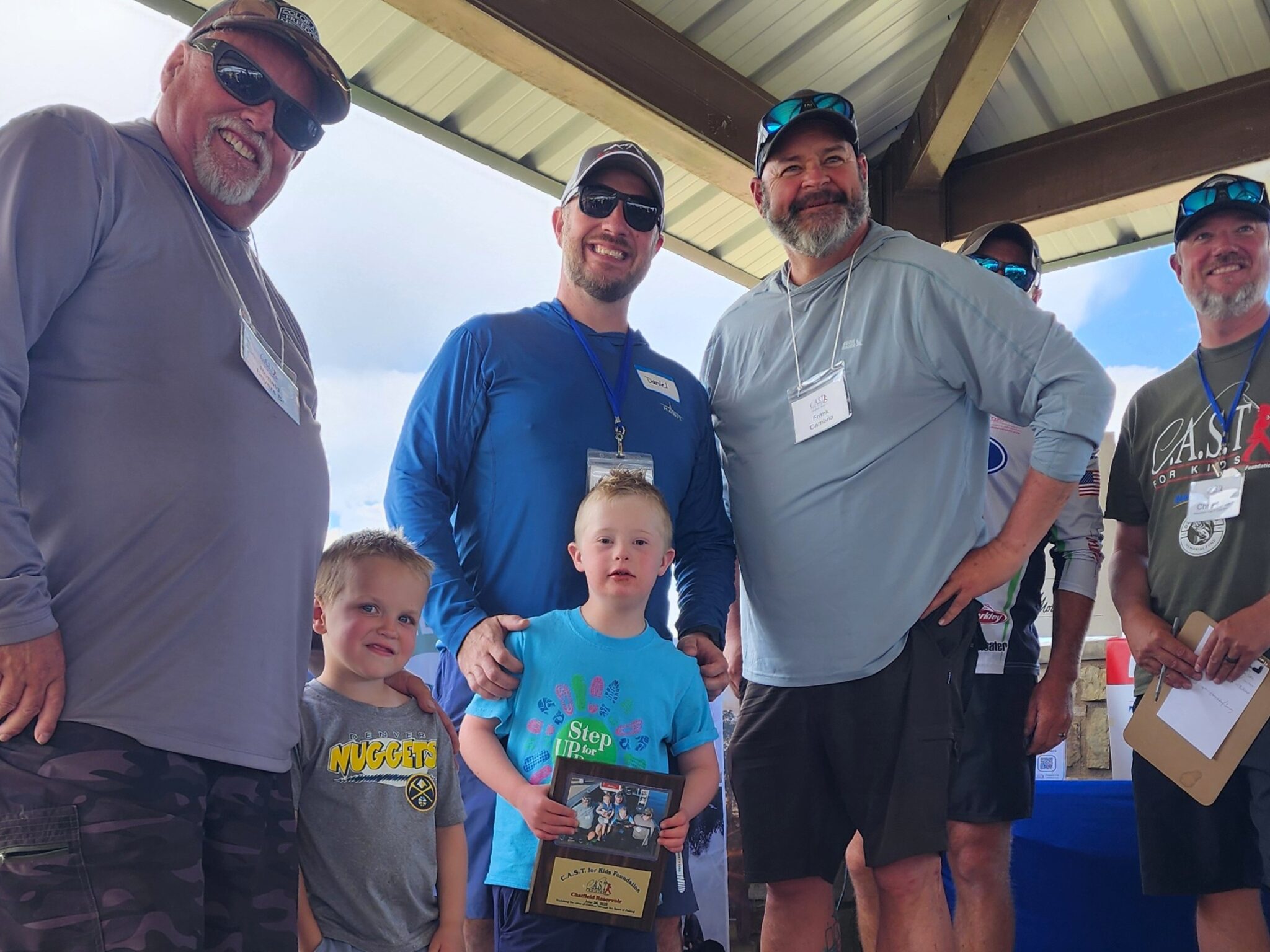 young boy holding plaque at chatfield reservoir