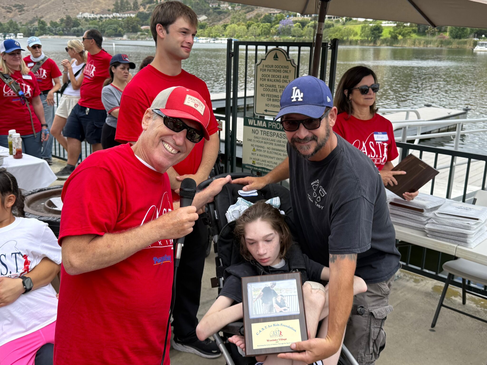 participant holding plaque at west lake village