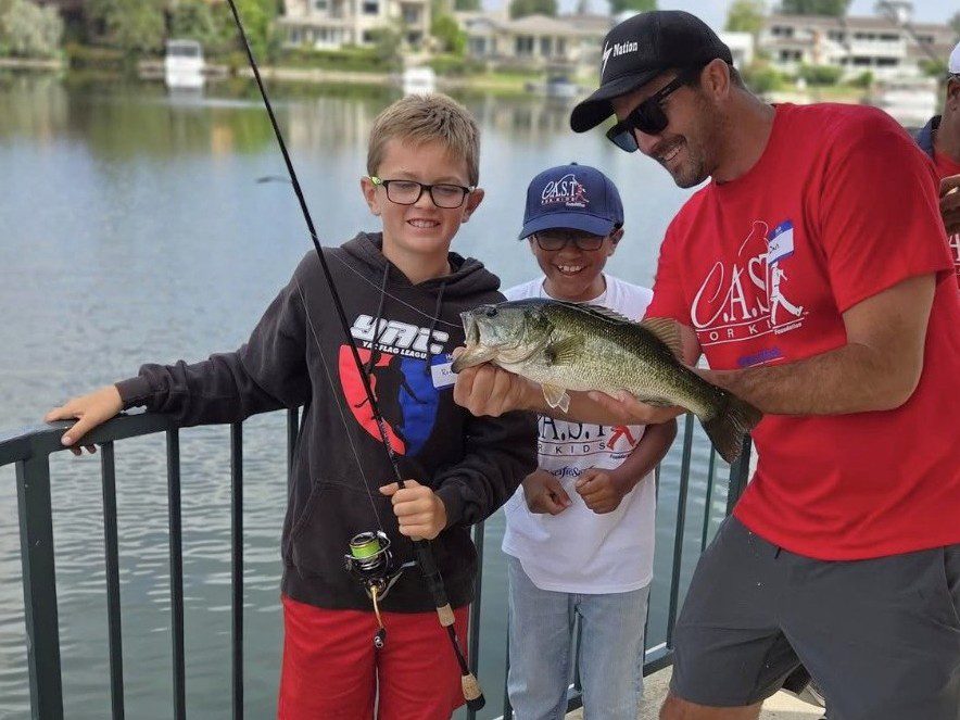 young child with big fish at west lake village