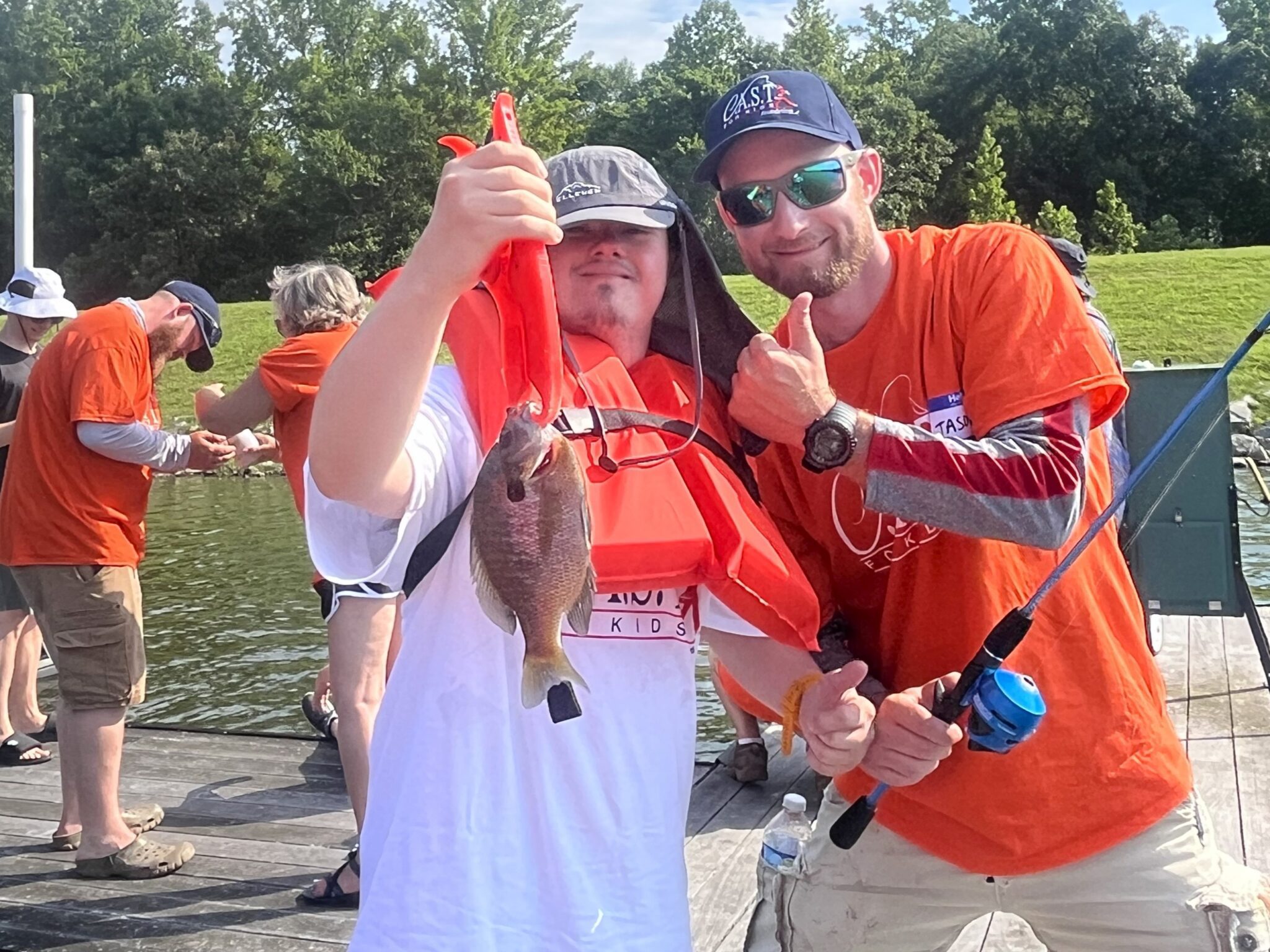 young boy with life jacket and fish at indian lake