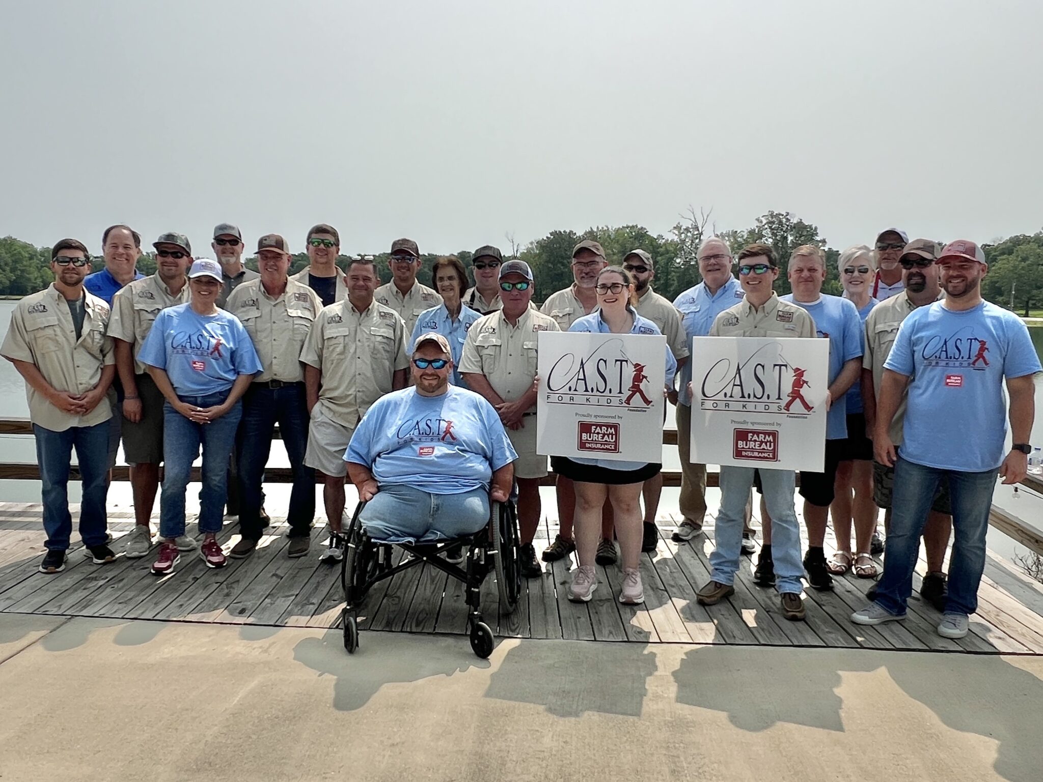 two participants showing fish at CC by the lake
