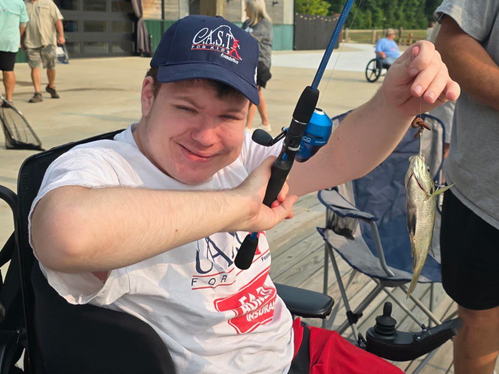 participants showing fish at CC by the lake