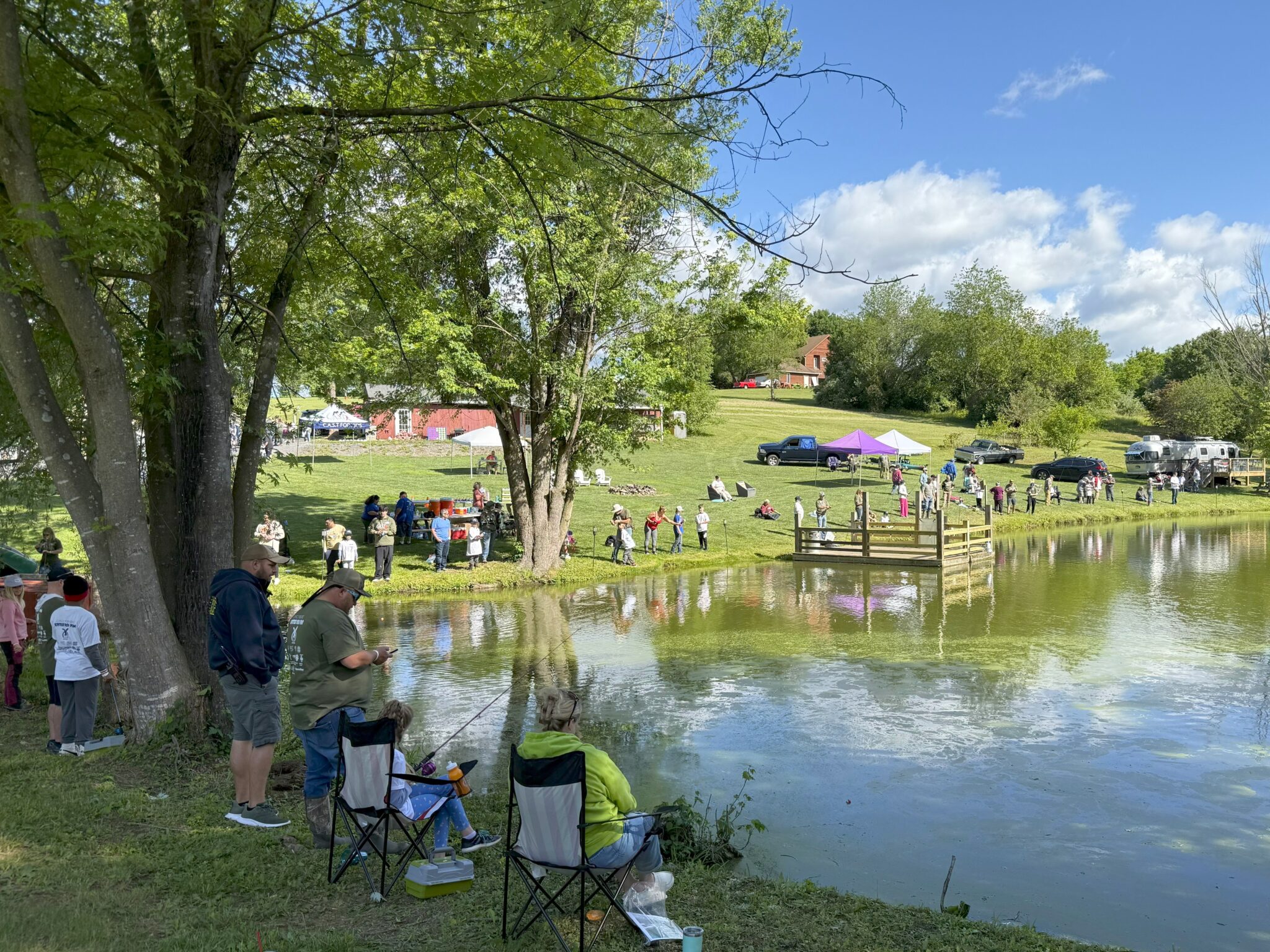 people on shoreline of spotted dog pond