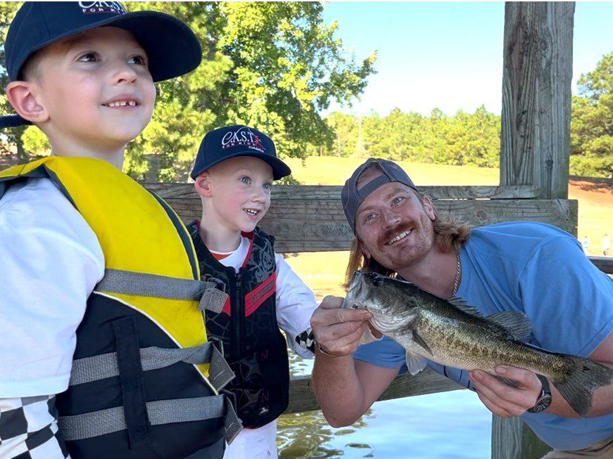 boy holding plaque at central lake pond