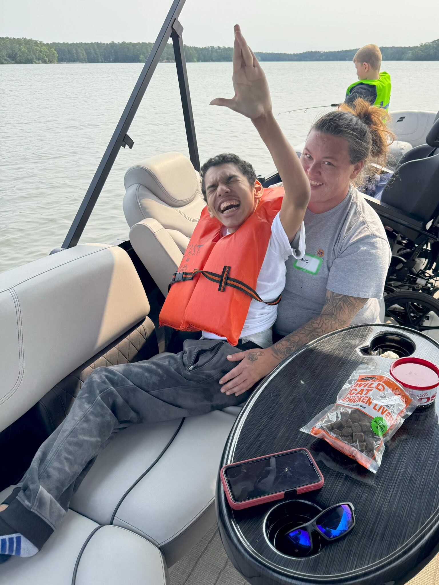 child waving on boat at lake thurmond