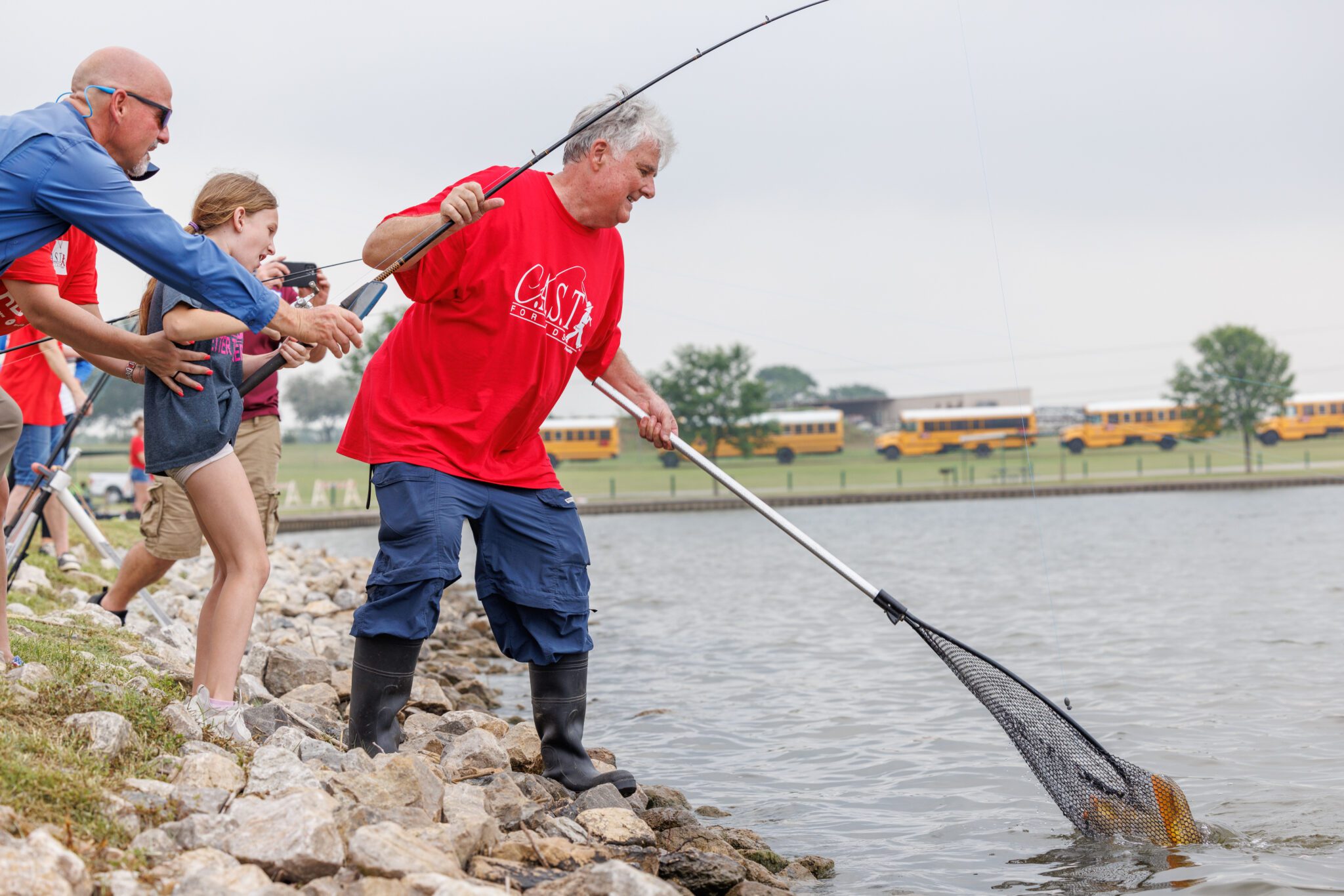 participants getting fish from the shore