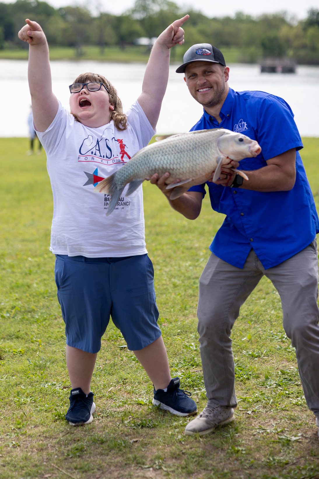 volunteer and participant with a fish