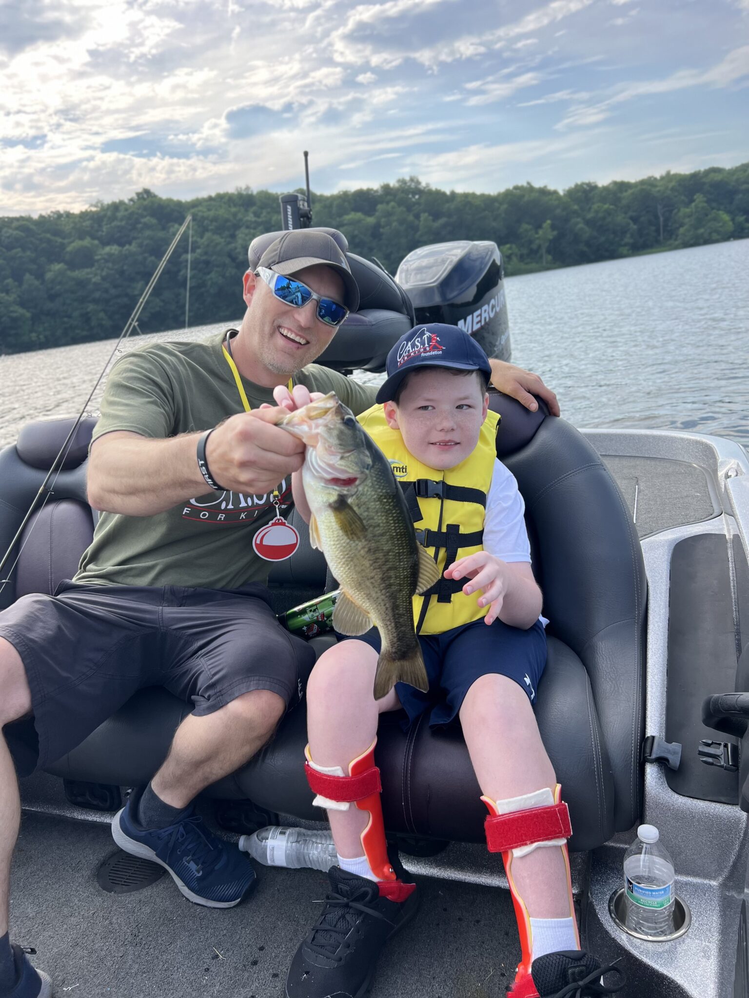 boater volunteer with a fish and participant
