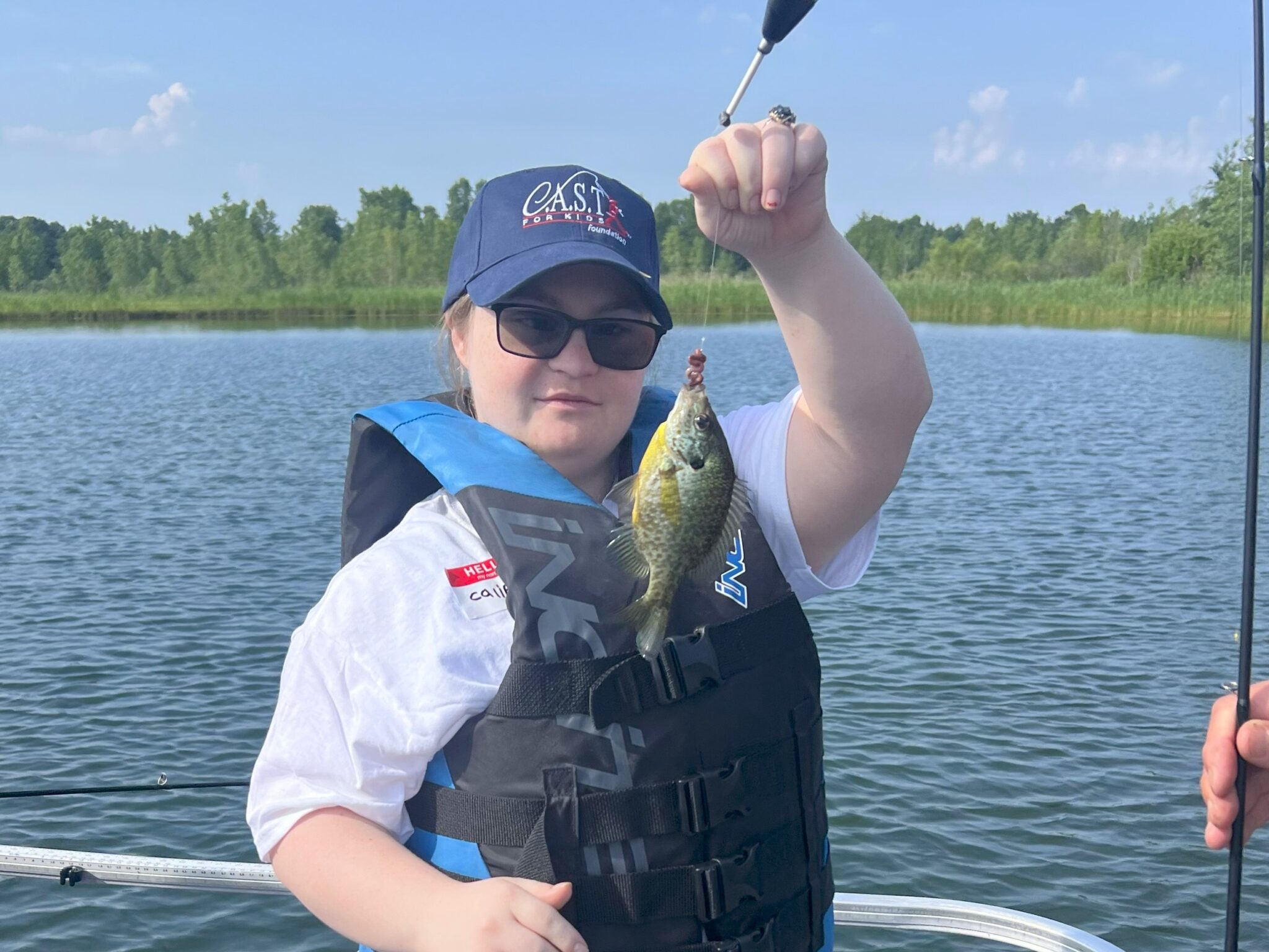 young participant holding fish at Happy Day