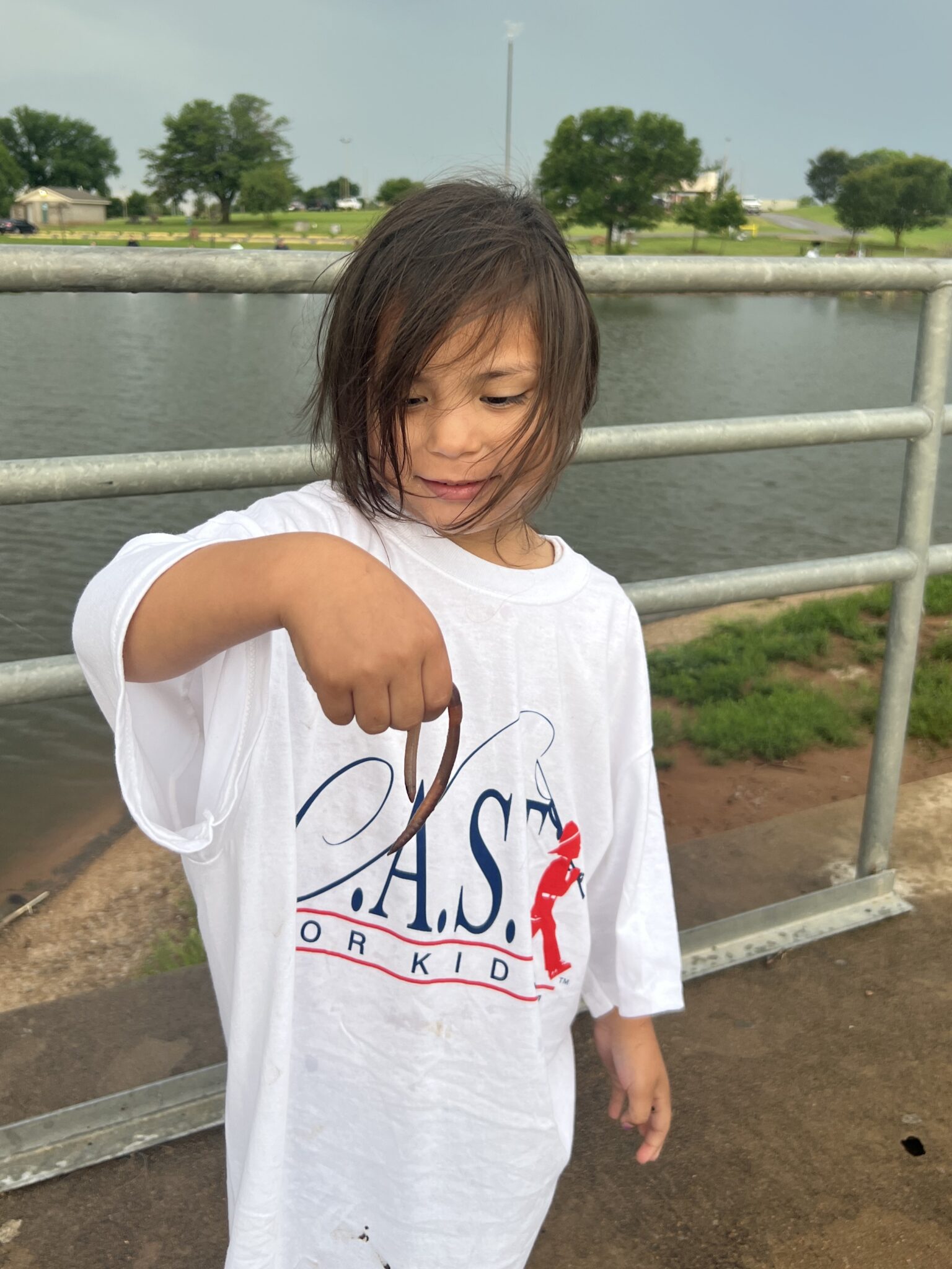 a kid holding a fish and pole