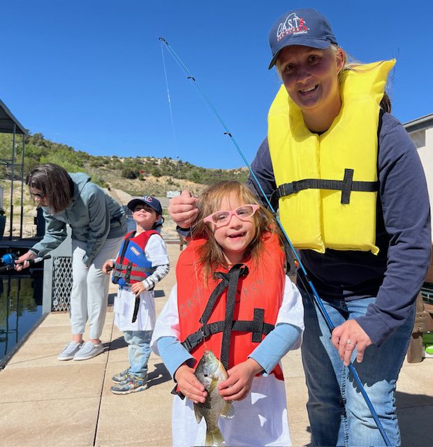 youth with CAST volunteer wearing life jackets