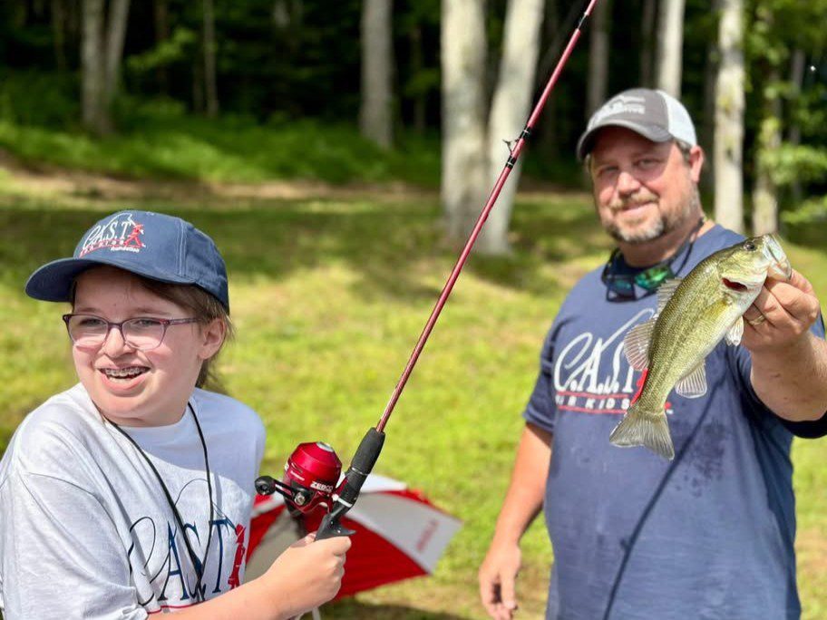participant showing off fish at Saugatuck River