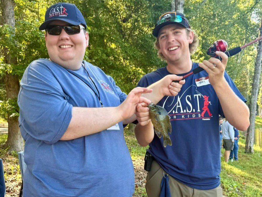 participant showing off fish at Saugatuck River